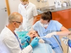 Dentist with nurses doing surgery on patient